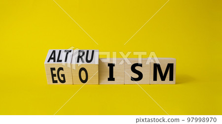 Altruism and Egoism symbol. Turned wooden cubes with words Egoism and Altruism. Beautiful yellow background. Business, psychological and Altruism and Egoism concept. Copy space Altruism and Egoism symbol. Turned wooden cubes with words Egoism and Altruism. Beautiful yellow background. Business, psychological and Altruism and Egoism concept. Copy space 97998970