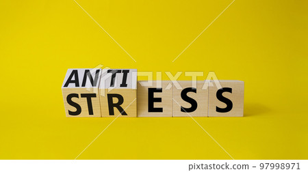 Antistress vs stress symbol. Concept words Antistress vs stress on wooden cubes. Beautiful yellow background. Antistress vs stress concept. Copy space Antistress vs stress symbol. Concept words Antistress vs stress on wooden cubes. Beautiful yellow background. Antistress vs stress concept. Copy space 97998971