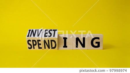 Investing and Spending symbol. Turned cubes with words Investing and Spending. Beautiful yellow background. Business and Investing and Spending concept. Copy space Investing and Spending symbol. Turned cubes with words Investing and Spending. Beautiful yellow background. Business and Investing and Spending concept. Copy space 97998974