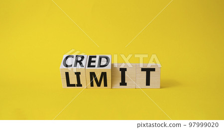 Credit and limit symbol. Turned wooden cubes with words credit and limit. Beautiful yellow background. Business and Credit limit concept. Copy space 97999020