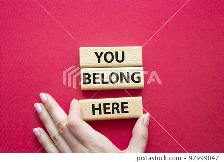 You belong here symbol. Wooden blocks with words You belong here. Beautiful red background. Businessman hand. Business and You belong here concept. Copy space. You belong here symbol. Wooden blocks with words You belong here. Beautiful red background. Businessman hand. Business and You belong here concept. Copy space. 97999047