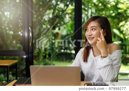Portrait of a designer holding a pen and smile as she can come up with new ideas. Portrait of a designer holding a pen and smile as she can come up with new ideas. 97999277