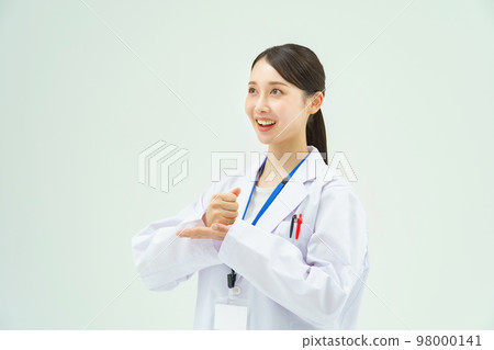 Woman in white coat giving back 98000141