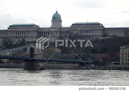 BUDAPEST, HUNGARY - 03 MAR 2019: The Royal Palace, site of the Hungarian National Gallery. Chain Bridge in the foreground BUDAPEST, HUNGARY - 03 MAR 2019: The Royal Palace, site of the Hungarian National Gallery. Chain Bridge in the foreground 98000196
