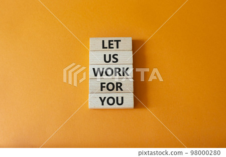 Let us work for you symbol. Wooden blocks with words Let us work for you. Beautiful orange background. Business and Let us work for you concept. Copy space. 98000280