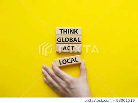 Think global act local symbol. Wooden blocks with words Think global act local. Beautiful yellow background. Businessman hand. Business and Think global act local concept. Copy space. 98001519