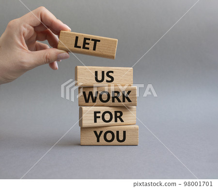 Let us work for you symbol. Wooden blocks with words Let us work for you. Beautiful grey background. Businessman hand. Business and Let us work for you concept. Copy space. 98001701