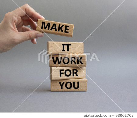 Make it work for you symbol. Business Concept words Make it work for you on wooden blocks. Beautiful grey background. Businessman hand. Business concept. Businessman hand. Copy space 98001702