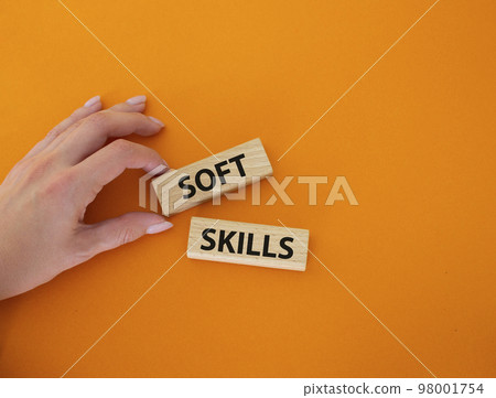 Soft skills symbol. Wooden blocks with words Soft skills. Beautiful orange background. Businessman hand. Business and Soft skills concept. Copy space. 98001754