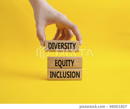 Diversity Equity Inclusion symbol. Concept words Diversity Equity Inclusion on wooden blocks. Beautiful yellow background. Bisinessman hand. Business and Diversity Equity Inclusion concept. Copy space 98001807
