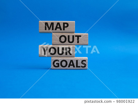 Goals symbol. Wooden blocks with words 'Map out your goals'. Beautiful blue background. Business and 'Map out your goals' concept. Copy space. Goals symbol. Wooden blocks with words 'Map out your goals'. Beautiful blue background. Business and 'Map out your goals' concept. Copy space. 98001922