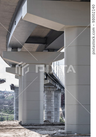 Pillar of bridge. Underside of an elevated roads. Gray pillars support the weight of the structure. Vital part of infrastructure Pillar of bridge. Underside of an elevated roads. Gray pillars support the weight of the structure. Vital part of infrastructure 98002140