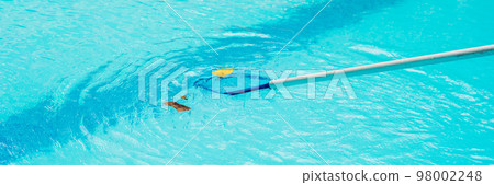 Cleaning swimming pool with cleaning net in the morning BANNER, long format 98002248