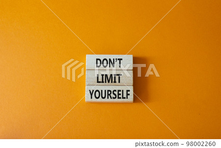 Do not limit yourself symbol. Concept words Do not limit yourself on wooden blocks. Beautiful orange background. Business and Do not limit yourself concept. Copy space Do not limit yourself symbol. Concept words Do not limit yourself on wooden blocks. Beautiful orange background. Business and Do not limit yourself concept. Copy space 98002260