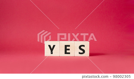 Yes symbol. Wooden blocks with word yes. Beautiful red background. Business and yes concept. Copy space. Yes symbol. Wooden blocks with word yes. Beautiful red background. Business and yes concept. Copy space. 98002305