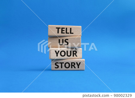 Tell us your story symbol. Concept words Tell us your story on wooden blocks. Beautiful blue background. Business and Tell us your story concept. Copy space. 98002329