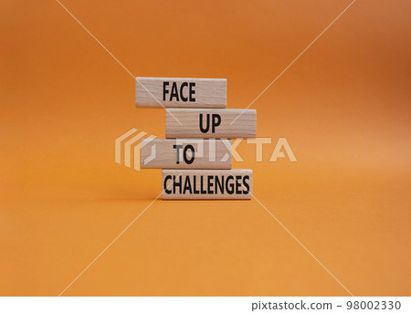 Face up to challenges symbol. Wooden blocks with words Face up to challenges. Beautiful orange background. Business and Face up to challenges concept. Copy space. Face up to challenges symbol. Wooden blocks with words Face up to challenges. Beautiful orange background. Business and Face up to challenges concept. Copy space. 98002330