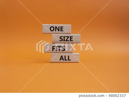 One size fits all symbol. Concept words One size fits all on wooden blocks. Beautiful orange background. Business and One size fits all concept. Copy space. 98002337