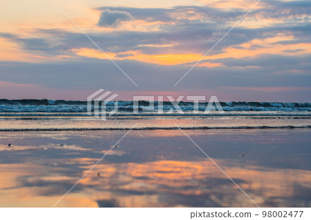 Sunset on the Kuta beach with reflection in the water on the island of Bali Sunset on the Kuta beach with reflection in the water on the island of Bali 98002477