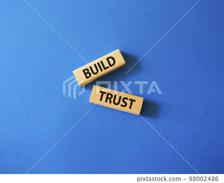 Build trust symbol. Wooden blocks with words Build trust. Beautiful blue background. Business and Build trust concept. Copy space. Build trust symbol. Wooden blocks with words Build trust. Beautiful blue background. Business and Build trust concept. Copy space. 98002486
