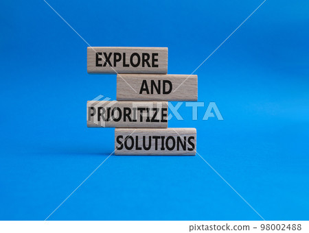Solution symbol. Wooden blocks with words Explore and prioritize solutions. Beautiful blue background. Business and solution concept. Copy space. Solution symbol. Wooden blocks with words Explore and prioritize solutions. Beautiful blue background. Business and solution concept. Copy space. 98002488