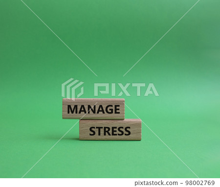 Manage stress symbol. Concept word Manage stress on wooden blocks. Beautiful green background. Business and Manage stress concept. Copy space Manage stress symbol. Concept word Manage stress on wooden blocks. Beautiful green background. Business and Manage stress concept. Copy space 98002769