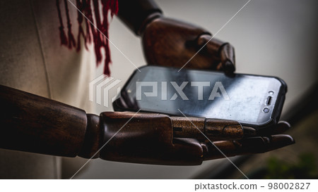 wooden hands with smartphone 98002827