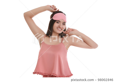 Beautiful woman wearing sleeping mask on white background. Bedtime 98002846