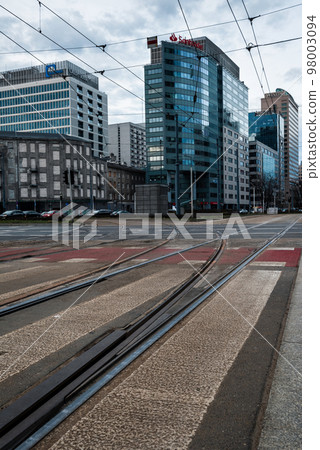 Pedestrian crossing over the road and tram track on the background of office buildings. 98003094