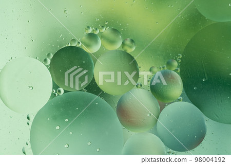 abstract background in green tones with fat drops forming bubbles abstract background in green tones with fat drops forming bubbles 98004192