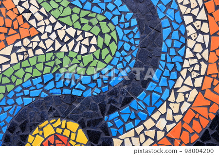 Colorful pattern ceramic tiles or mosaic. Detail of beautiful old collapsing abstract ceramic mosaic adorned building. Venetian mosaic as decorative background. Selective focus. Colorful pattern ceramic tiles or mosaic. Detail of beautiful old collapsing abstract ceramic mosaic adorned building. Venetian mosaic as decorative background. Selective focus. 98004200