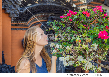 Young woman tourist on the background of Tanah Lot - Temple in the Ocean. Bali, Indonesia 98004298
