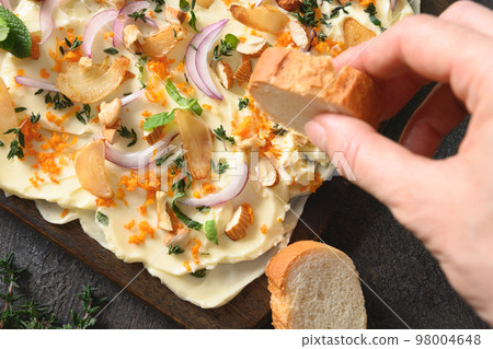 Butterboard with onion, garlic, orange, herbs and crispy baguette. Butterboard with onion, garlic, orange, herbs and crispy baguette. 98004648