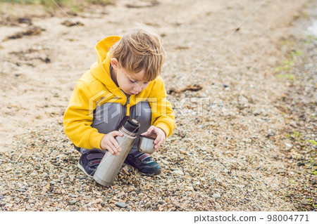 Young woman feeding an African Sacred ibis 98004771