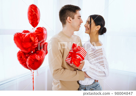Valentine's Day concept. Happy couple in love with. Young loving couple celebrating Valentine's Day Valentine's Day concept. Happy couple in love with. Young loving couple celebrating Valentine's Day 98004847