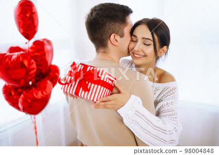 Valentine's Day concept. Happy couple in love with. Young loving couple celebrating Valentine's Day Valentine's Day concept. Happy couple in love with. Young loving couple celebrating Valentine's Day 98004848