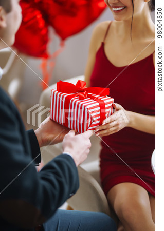 Valentine's Day concept. A loving couple celebrating Valentine's Day in the restaurant. Valentine's Day concept. A loving couple celebrating Valentine's Day in the restaurant. 98004850