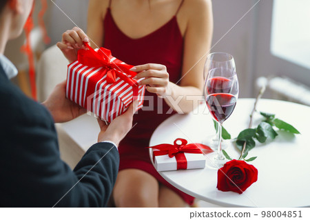 Valentine's Day concept. A loving couple celebrating Valentine's Day in the restaurant. Valentine's Day concept. A loving couple celebrating Valentine's Day in the restaurant. 98004851