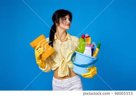 woman in gloves holding bucket with cleaning supplies woman in gloves holding bucket with cleaning supplies 98005553