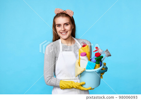 woman in gloves holding bucket with cleaning supplies 98006093