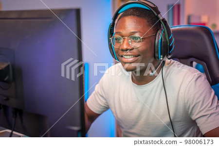 African American man playing action video games on computer stream online broadcast live gaming. African American man playing action video games on computer stream online broadcast live gaming. 98006173