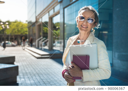 Middle-aged confident, focused and powerful business woman looking at camera. Middle-aged confident, focused and powerful business woman looking at camera. 98006367