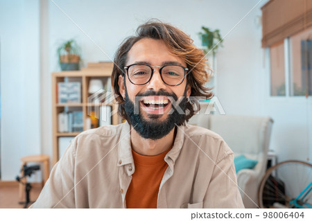 Portrait of freelancer man at home office, looking and smiling at camera. Happy entrepreneur guy. Portrait of freelancer man at home office, looking and smiling at camera. Happy entrepreneur guy. 98006404