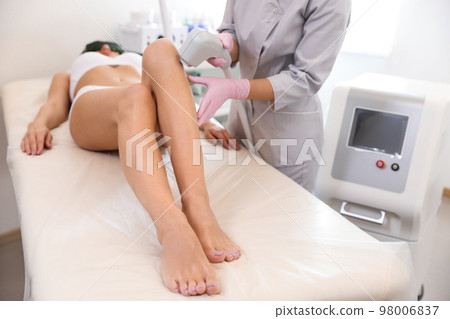 Young woman undergoing laser epilation procedure in beauty salon, closeup Young woman undergoing laser epilation procedure in beauty salon, closeup 98006837