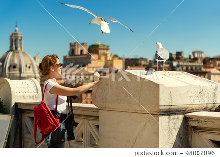 Girl tourist looks at Rome from Capitoline Hill top, Italy, Europe Girl tourist looks at Rome from Capitoline Hill top, Italy, Europe 98007096