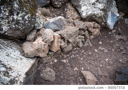 Closeup of large rocks or boulders near the mountains. Large multicolored granites. Details of big grey stone structures with orange particles shining in the sunlight. Closeup of large rocks or boulders near the mountains. Large multicolored granites. Details of big grey stone structures with orange particles shining in the sunlight. 98007358