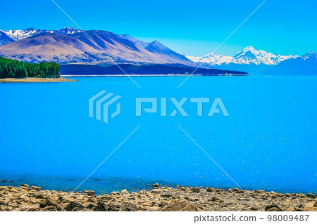 Blue Lake Pukaki and Mt Cook massif, New Zealand South island idyllic landscape Blue Lake Pukaki and Mt Cook massif, New Zealand South island idyllic landscape 98009487