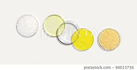 Microcrystalline wax, Poly Aluminium chloride liquid, Potassium Chromate and Candelilla wax in Petri dish on white laboratory table. Chemical ingredient for Cosmetic and Toiletries product. Top View 98013738