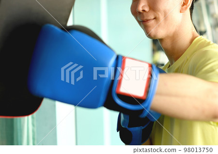 Men punching and trainer with mitts Men punching and trainer with mitts 98013750