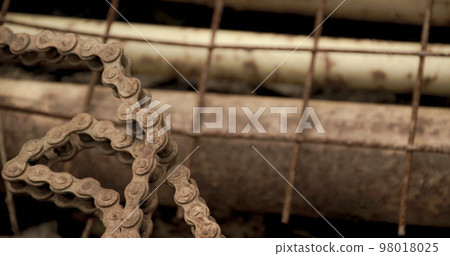 Scrap metal for recycling background. a lot of different rusty industrial part detail for melt and reused. Old rusty metal surface. Abstract background for design purpose. Warm orange color. Random Scrap metal for recycling background. a lot of different rusty industrial part detail for melt and reused. Old rusty metal surface. Abstract background for design purpose. Warm orange color. Random 98018025